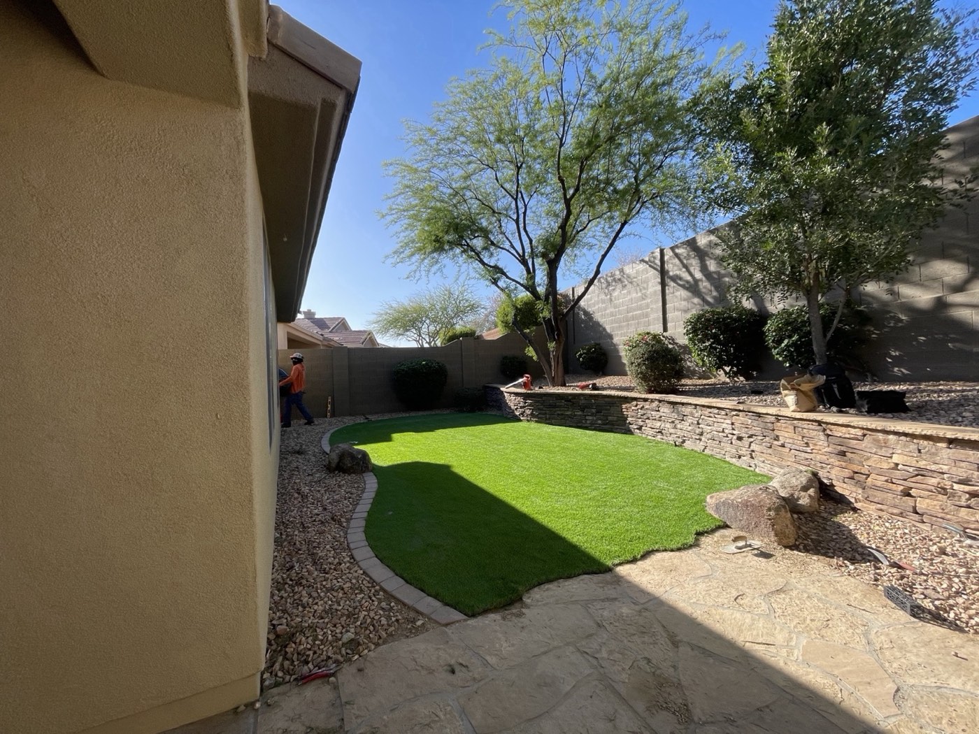 Putting green with stacked stone wall